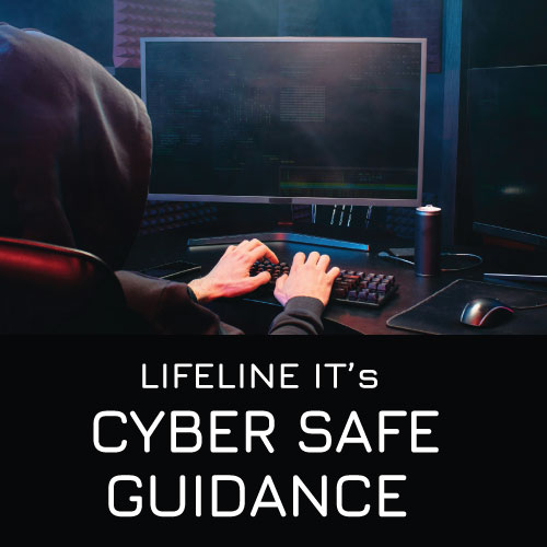 Sinister-looking man in black hoodie working on a PC
