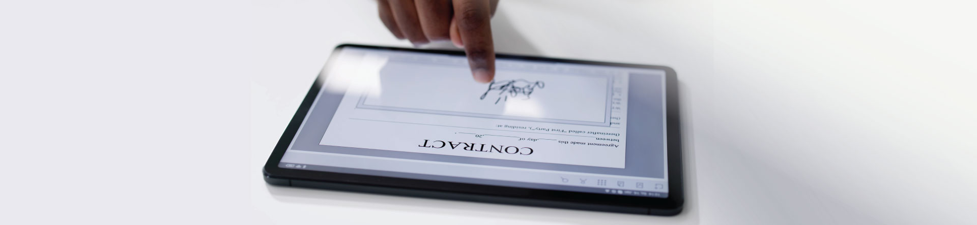 Cyber security - person signing a legal contract electronically on a tablet