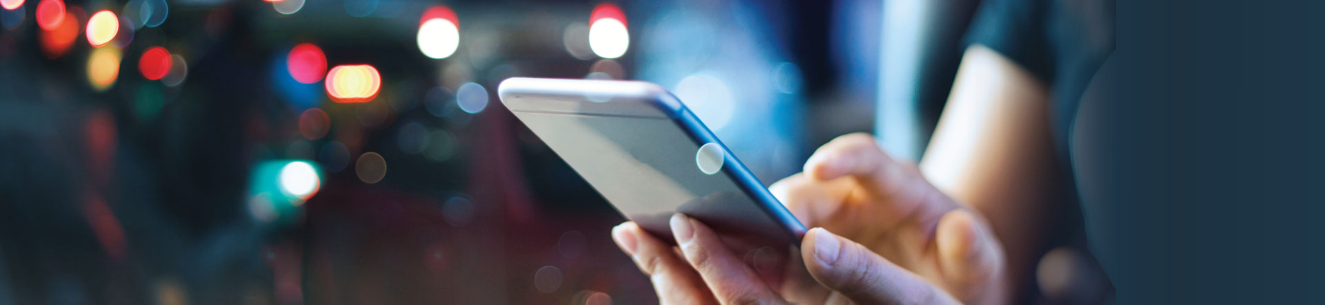 A person using their mobile in public to show public wifi dangers