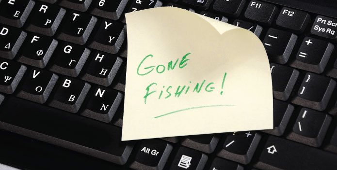Out Of Office message represented by a postit note saying Gone Fishing